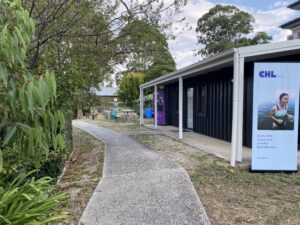 A small building in a garden that has been renovated into a community space.